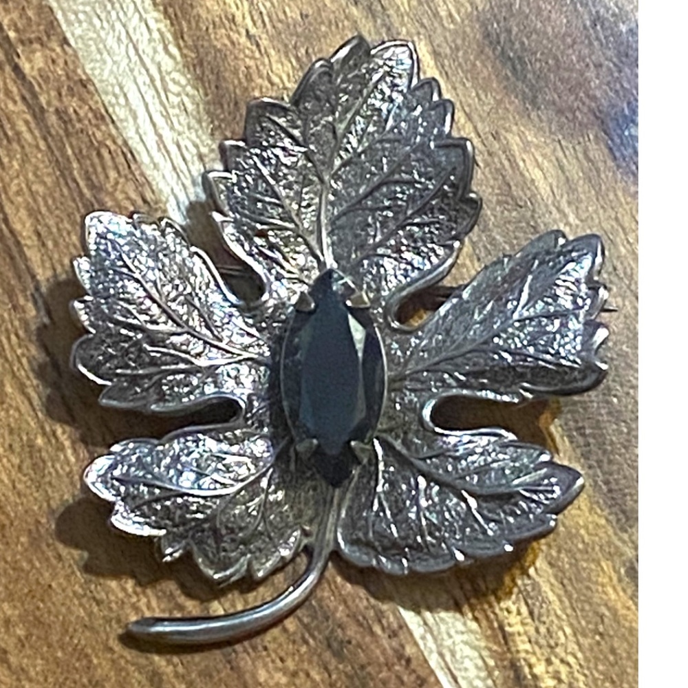 Vintage silver toned maple leaf pin with faceted Hematite “black Diamond” stone